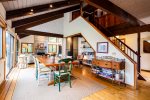 Gorgeous open living and dining space with large dining table and sliders onto the back deck